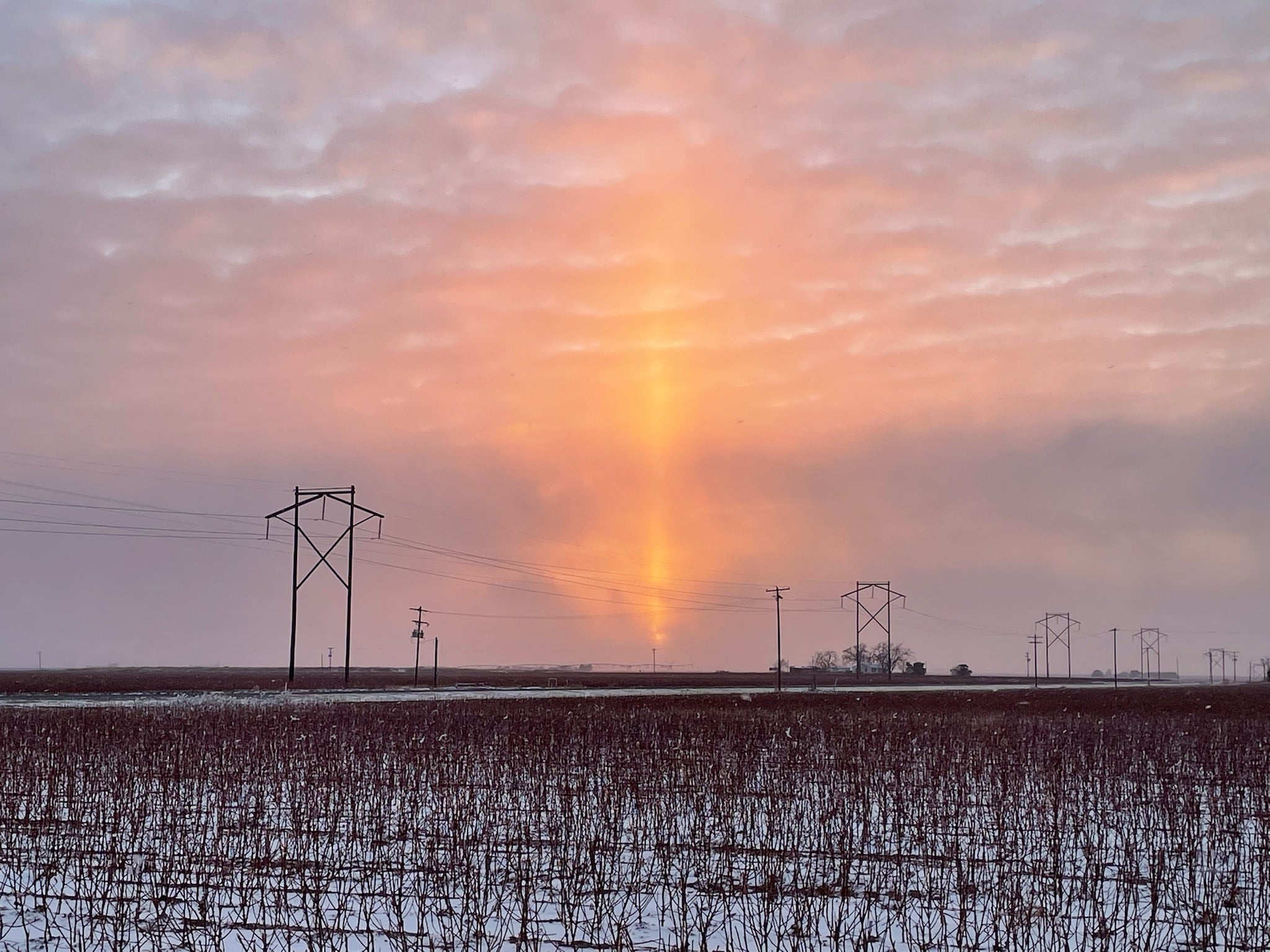It's a Sun pillar! These are more commonly seen up in the Arctic at sunrise or sunset, but it was just cold enough and just clear enough to spy one in West Texas on Thursday evening. The picture is courtesy of the West Texas Mesonet.