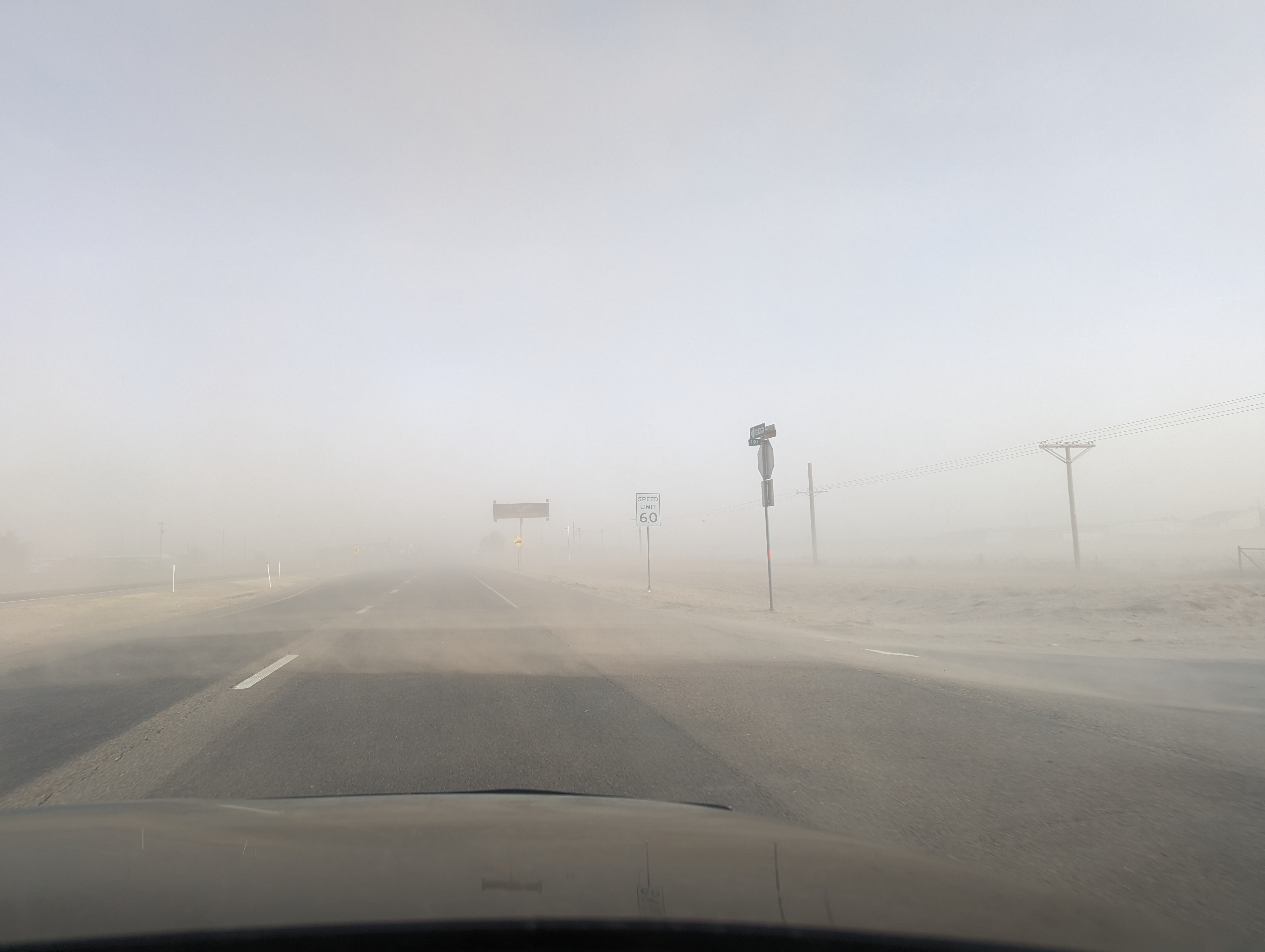 Thick blowing dust blowing across Highway 84 immediately southeast of Muleshoe late Wednesday afternoon (22 February 2023). The image is courtesy Gary Skwira.