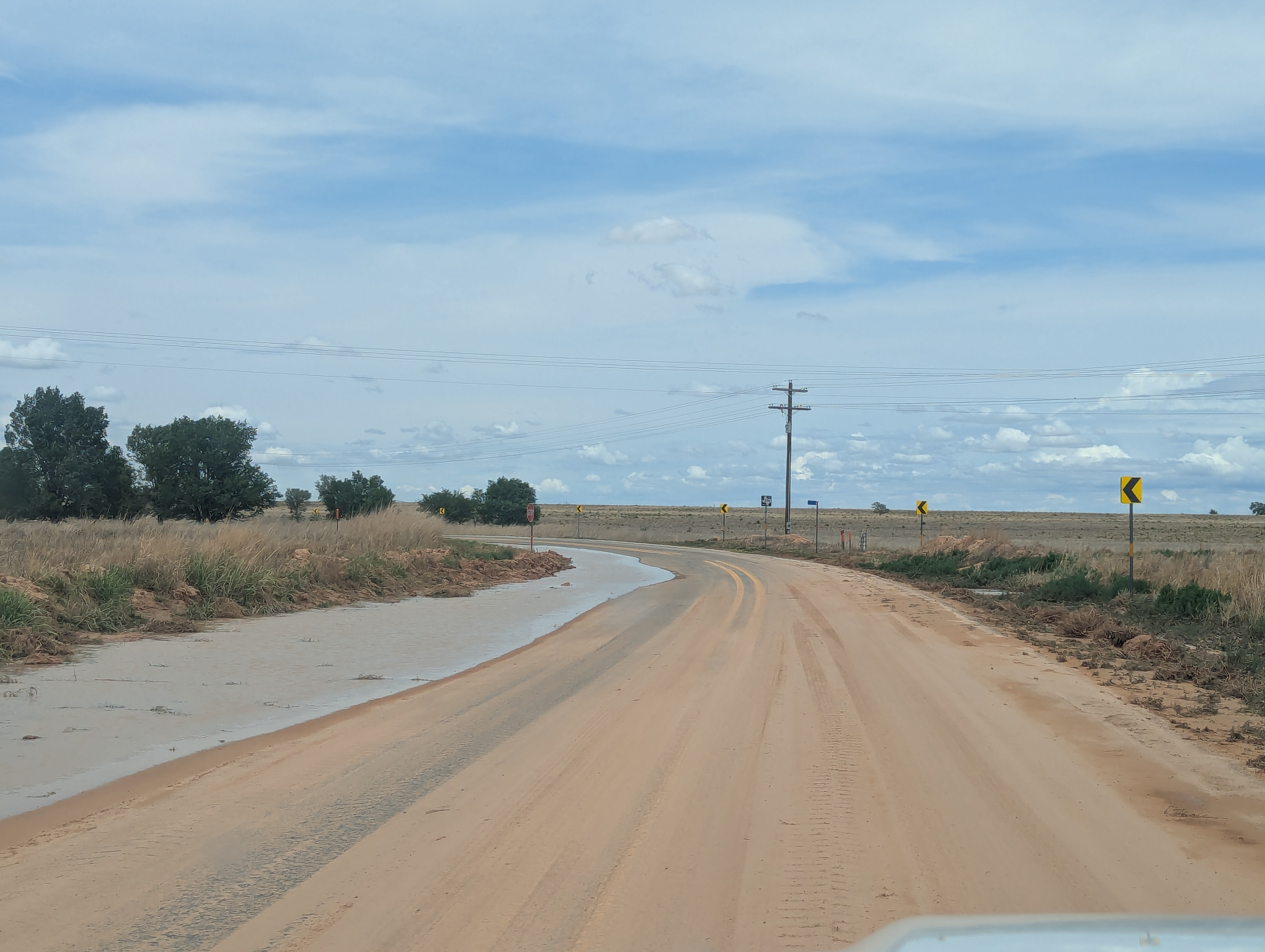 Muddy and water-covered roadway south of Maple on FM 596, in northern Cochran County, on Wednesday (3 June 2026).