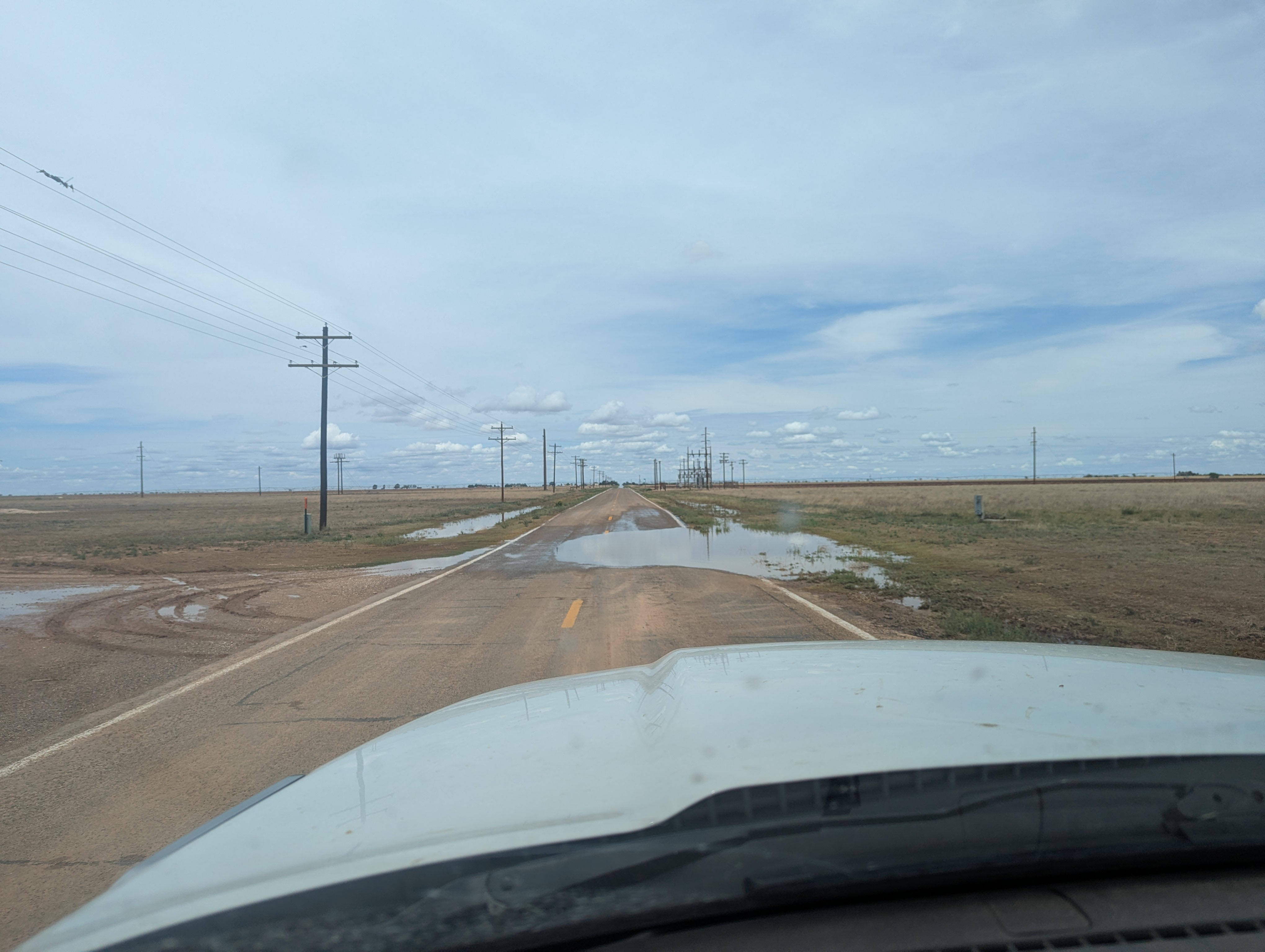 Muddy and water-covered roadway south of Maple on FM 596, in northern Cochran County, on Wednesday (3 June 2026).
